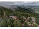 A cabin, a car, and a main house on a rock outcropping surrounded by nature at 1150 Madge Gulch Rd, Sedalia, CO 80135