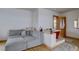 Unique primary bathroom with red soaking tub, hardwood floors, grey sofa, and access to additional rooms at 1150 Madge Gulch Rd, Sedalia, CO 80135