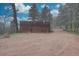 Spacious garage, mature trees, and landscaping in this picturesque shot of this lovely property at 1150 Madge Gulch Rd, Sedalia, CO 80135