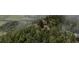 Home perched atop a rock outcropping surrounded by mature trees at 1150 Madge Gulch Rd, Sedalia, CO 80135