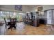 Kitchen area with tiled floors, island, stainless fridge, and eating area with scenic views at 1150 Madge Gulch Rd, Sedalia, CO 80135