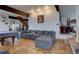 Open floorplan living room with tile floors, sectional sofa, and a view of other spaces at 1150 Madge Gulch Rd, Sedalia, CO 80135