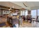 Open space containing kitchen island, staircase, dining area, and an outside view at 1150 Madge Gulch Rd, Sedalia, CO 80135
