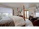 Bedroom with four poster bed and view from a large window and a mounted deer head at 1150 Madge Gulch Rd, Sedalia, CO 80135