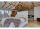 Bright main bedroom with beautiful hardwood floors, exposed beams, plus views into sitting room and outdoors at 1150 Madge Gulch Rd, Sedalia, CO 80135