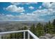 Expansive view from the deck with beautiful blue skies, scattered clouds, and rolling green hills in the distance at 1150 Madge Gulch Rd, Sedalia, CO 80135