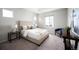 Cozy bedroom featuring a comfortable bed with plush pillows and a chair by a bright window at 10786 Bear Cub Dr, Broomfield, CO 80021