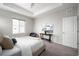 Well-lit bedroom with a tray ceiling, comfy bed, and a view from the window at 10786 Bear Cub Dr, Broomfield, CO 80021