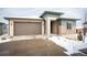 Charming single-Gathering home boasting a two-car garage, stone accents, and covered entryway at 10786 Bear Cub Dr, Broomfield, CO 80021