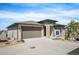 A two-story single-Gathering home showcasing a two-car garage, complemented by meticulous landscaping and stone detailing at 10786 Bear Cub Dr, Broomfield, CO 80021