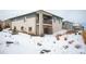 Charming exterior view of the home featuring multiple stories and a winter landscape at 10786 Bear Cub Dr, Broomfield, CO 80021