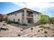 Rear exterior view showcasing a two-story home with balcony and a rock garden at 10786 Bear Cub Dr, Broomfield, CO 80021