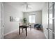 Bright, carpeted home office with a window, a desk, and glass French doors at 10786 Bear Cub Dr, Broomfield, CO 80021