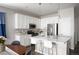 Bright, white kitchen features stainless steel appliances and an eat-in breakfast bar at 10786 Bear Cub Dr, Broomfield, CO 80021