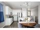 Eat-in kitchen featuring stainless steel appliances, white cabinets, and quartz countertops at 10786 Bear Cub Dr, Broomfield, CO 80021