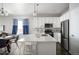 Modern kitchen features stainless steel appliances, a large island, and white cabinetry at 10786 Bear Cub Dr, Broomfield, CO 80021