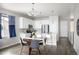 Bright, white kitchen features stainless steel appliances and an eat-in breakfast bar at 10786 Bear Cub Dr, Broomfield, CO 80021