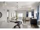 Bright living room with a dining area leading to a balcony overlooking the scenic outside at 10786 Bear Cub Dr, Broomfield, CO 80021