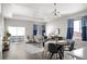 Open-concept living area offers a cohesive space with a modern sofa, dining table, and access to a balcony at 10786 Bear Cub Dr, Broomfield, CO 80021
