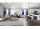 Open-concept living room and dining area with hardwood floors and modern lighting at 10786 Bear Cub Dr, Broomfield, CO 80021