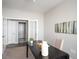 Bright office with a dark desk, neutral walls, and a doorway leading to another room at 10786 Bear Cub Dr, Broomfield, CO 80021
