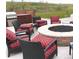 Outdoor patio area with a built-in grill, seating around a fire pit, and landscape views at 10786 Bear Cub Dr, Broomfield, CO 80021