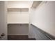 Walk-in closet with shelving units, rods, and neutral carpeting at 10786 Bear Cub Dr, Broomfield, CO 80021