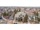 Aerial view of the complex, showing mature landscaping, community pool and ample parking at 4899 S Dudley St # 18A, Littleton, CO 80123