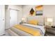 Stylishly decorated bedroom with neutral tones, featuring modern art and a sliding barn door at 4899 S Dudley St # 18A, Littleton, CO 80123