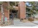 Multi-level condo building with brick accents, stone landscaping, and stairway entrances at 4899 S Dudley St # 18A, Littleton, CO 80123