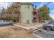 Three-story apartment building showcasing well-maintained landscaping and convenient parking at 4899 S Dudley St # 18A, Littleton, CO 80123