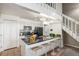 Open kitchen featuring a black countertop island with seating, white cabinets, and modern appliances at 4899 S Dudley St # 18A, Littleton, CO 80123