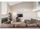 Bright living room featuring a fireplace, high ceilings, and a cozy, oversized sectional couch at 4899 S Dudley St # 18A, Littleton, CO 80123