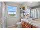 Bathroom with natural light from the window, tile floor, wood vanity and mirror at 688 Cinnabar Ln, Castle Rock, CO 80108