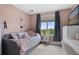 Cozy bedroom with pink walls, a window, and a daybed with decorative pillows at 688 Cinnabar Ln, Castle Rock, CO 80108