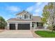 Charming two-story home with a three-car garage and well-manicured lawn at 688 Cinnabar Ln, Castle Rock, CO 80108