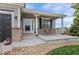 Inviting front porch features a swing and decorative accents at 688 Cinnabar Ln, Castle Rock, CO 80108
