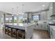 Bright kitchen features a large island with seating and modern appliances at 688 Cinnabar Ln, Castle Rock, CO 80108