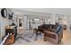 Open living area features a stylish rug, stainless steel refrigerator, and access to other living areas at 688 Cinnabar Ln, Castle Rock, CO 80108