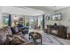 Bright living room with fireplace, stylish rug, and walkout access to a deck for outdoor living at 688 Cinnabar Ln, Castle Rock, CO 80108