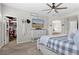 Bright main bedroom featuring an ensuite bath, walk-in closet, and a ceiling fan at 688 Cinnabar Ln, Castle Rock, CO 80108