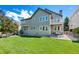 Backyard with well-manicured lawn, covered patio, and balcony perfect for outdoor enjoyment at 85 Willowleaf Dr, Littleton, CO 80127