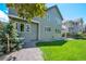 Exterior view of the home showing the backyard with green lawn and landscaping at 85 Willowleaf Dr, Littleton, CO 80127