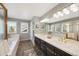 Bathroom with double sink vanity, soaking tub, and tiled floors at 85 Willowleaf Dr, Littleton, CO 80127