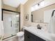 Modern bathroom featuring a sleek vanity, walk-in shower with glass door, and contemporary fixtures at 85 Willowleaf Dr, Littleton, CO 80127