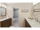Bathroom with dual vanities, tiled floors, and a shower-tub combo in a separate room at 85 Willowleaf Dr, Littleton, CO 80127
