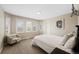 Bedroom with windows, white bedding, and comfortable chair at 85 Willowleaf Dr, Littleton, CO 80127