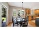 Charming dining area with natural light and views into the backyard and connected to the kitchen at 85 Willowleaf Dr, Littleton, CO 80127
