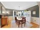 Formal dining room with hardwood floors, elegant lighting, and a stylish china cabinet at 85 Willowleaf Dr, Littleton, CO 80127