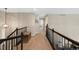 Upstairs hallway featuring neutral tones, wood trim, and carpet at 85 Willowleaf Dr, Littleton, CO 80127